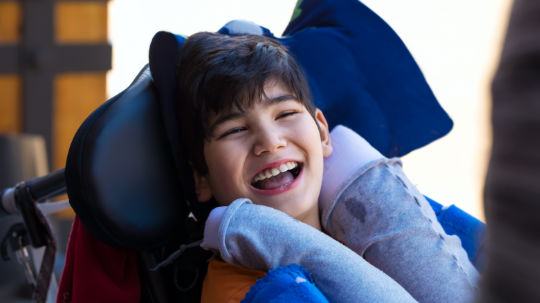 A happy young boy suffering from Cerebral Palsy.