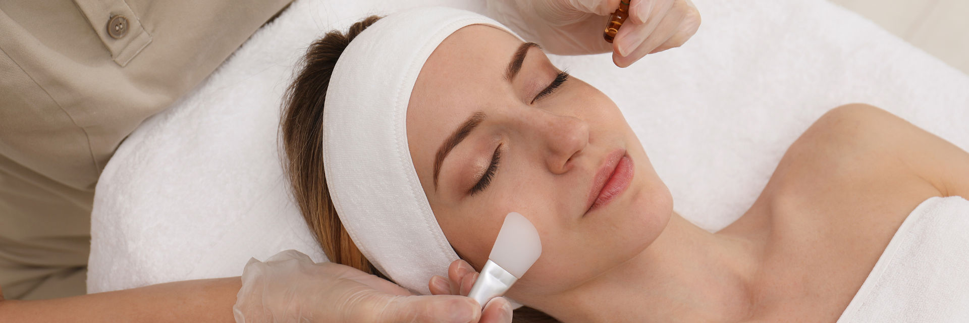 Woman undergoing spa facial treatment.