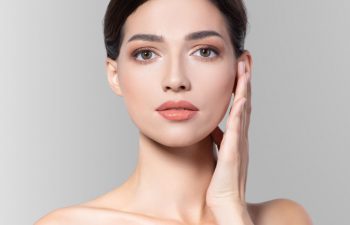 A beautiful woman touching her ear.