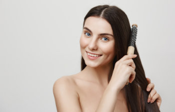 happy woman combs her hair